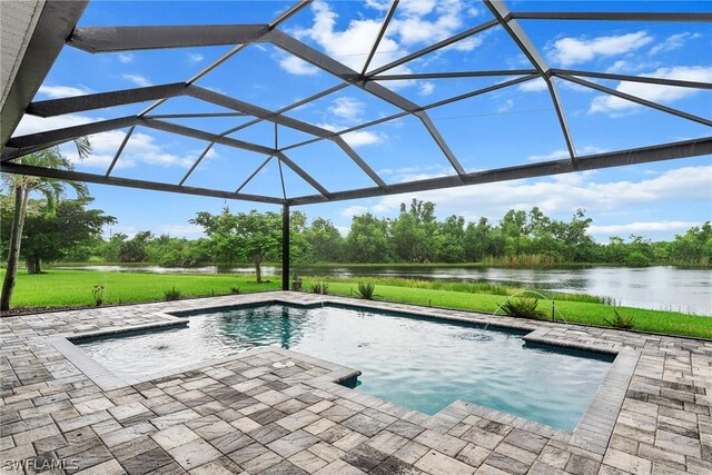 view of swimming pool featuring a patio area, a water view, pool water feature, and glass enclosure