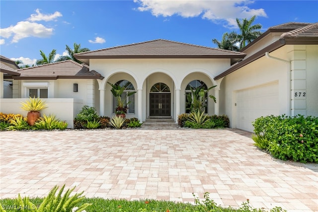 doorway to property with a garage