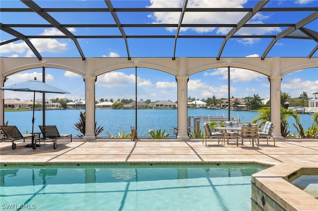 view of swimming pool with a patio, an in ground hot tub, and a water view