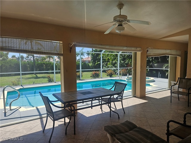 exterior space featuring glass enclosure, a patio area, and ceiling fan