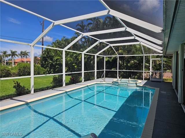 view of pool featuring an in ground hot tub and a lanai