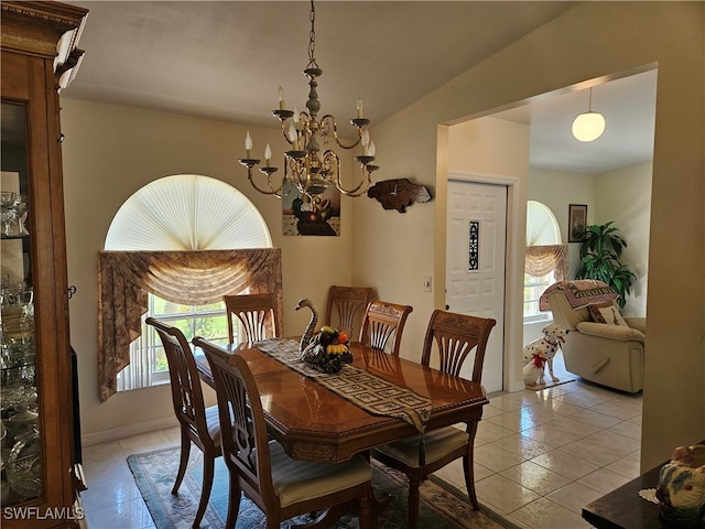 tiled dining space featuring lofted ceiling and a chandelier