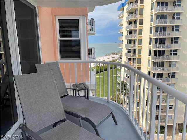 balcony with a water view and central AC unit