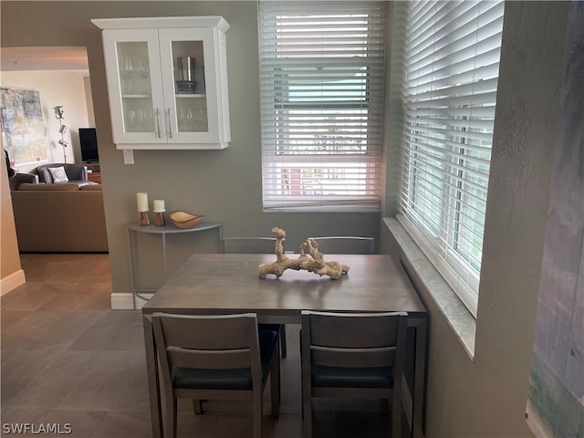 dining space with light tile patterned floors