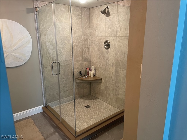 bathroom featuring a shower with door and tile patterned flooring