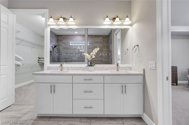 bathroom with double vanity and tile patterned flooring