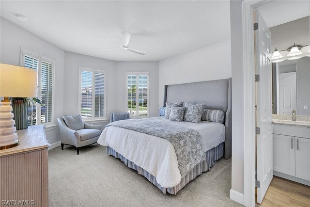 20012 Tavernier Dr, Estero, FL 33928 - bedroom with baseboards, ceiling fan, a sink, and light colored carpet