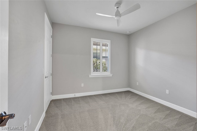 carpeted empty room featuring ceiling fan