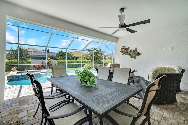 unfurnished sunroom with ceiling fan