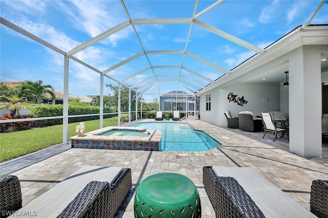 view of swimming pool with an in ground hot tub, a patio, ceiling fan, and glass enclosure