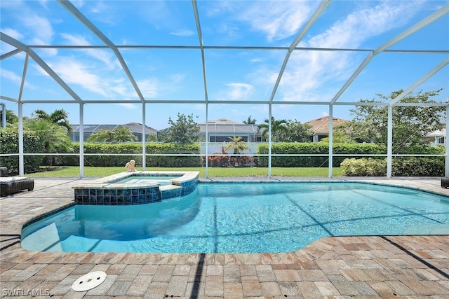 view of pool featuring an in ground hot tub, a patio area, and glass enclosure