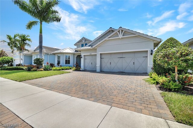 view of front of home featuring a garage and a front yard