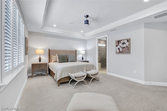 carpeted bedroom featuring connected bathroom, ceiling fan, a raised ceiling, and crown molding