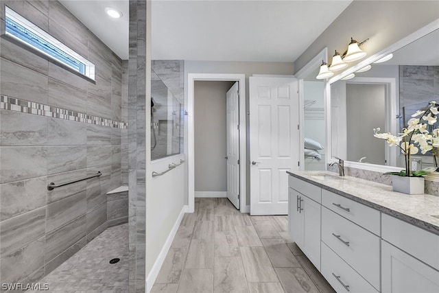 bathroom featuring vanity and a tile shower