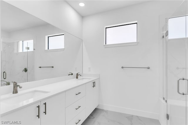 bathroom featuring tile patterned floors, double vanity, and a wealth of natural light