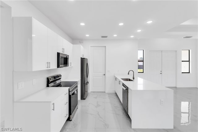 kitchen featuring white cabinetry, light tile patterned floors, backsplash, stainless steel appliances, and sink