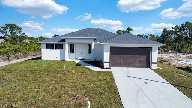 view of front of house with a garage and a front yard