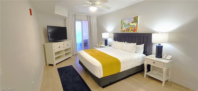 bedroom featuring ceiling fan, crown molding, and light hardwood / wood-style floors