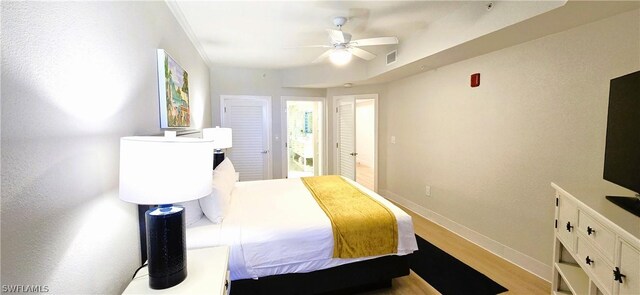 bedroom with light hardwood / wood-style flooring, ceiling fan, and crown molding