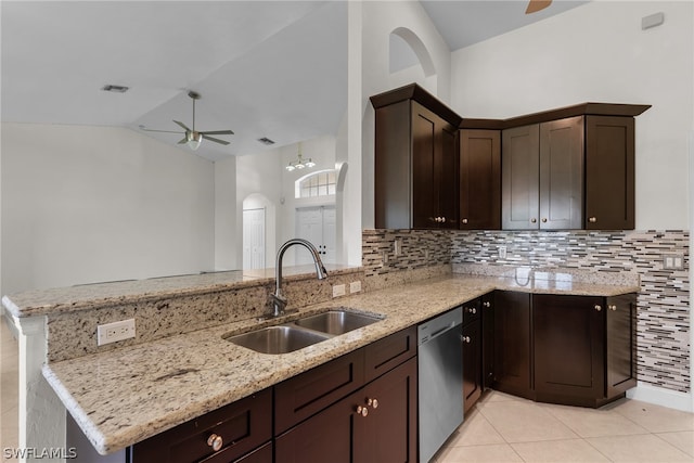 kitchen featuring vaulted ceiling, sink, kitchen peninsula, light stone countertops, and ceiling fan