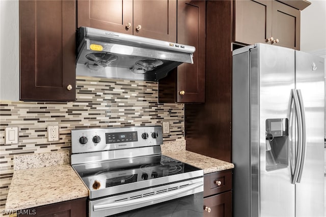 kitchen with decorative backsplash, light stone counters, stainless steel appliances, and dark brown cabinets