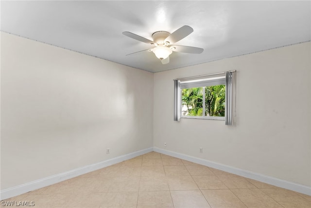 tiled empty room with ceiling fan