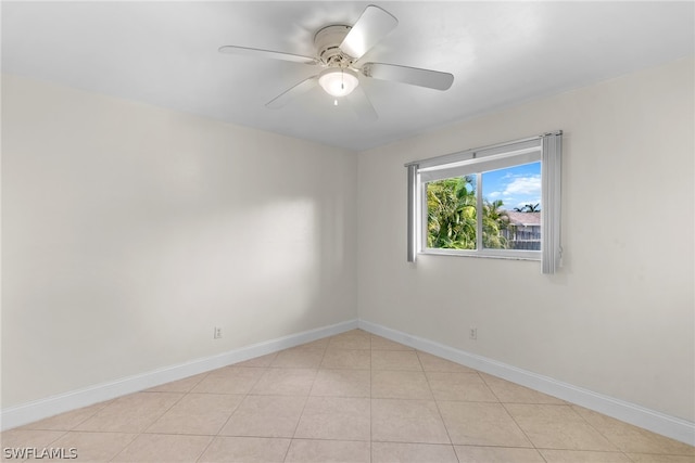 tiled empty room with ceiling fan