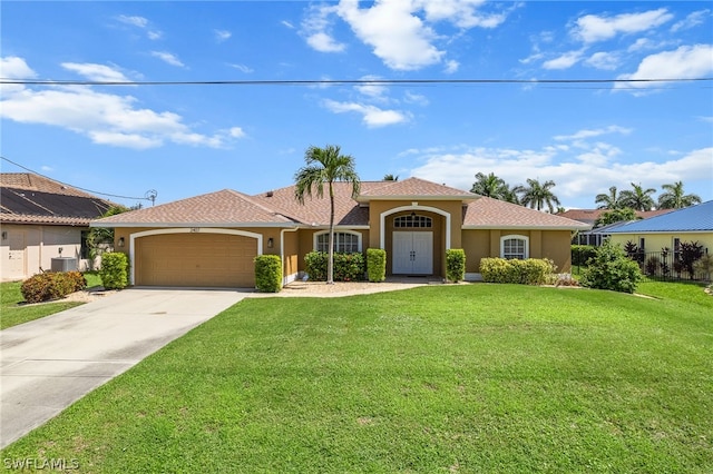 view of front of house featuring a garage, solar panels, and a front yard