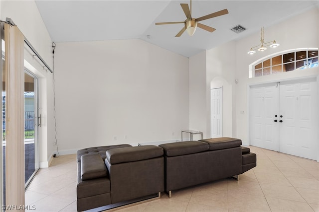 living room featuring a barn door, light tile patterned floors, high vaulted ceiling, and ceiling fan