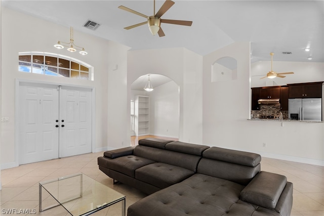 living room featuring high vaulted ceiling, light tile patterned floors, and ceiling fan