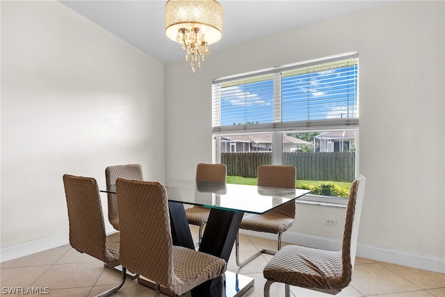 dining area featuring a chandelier and light tile patterned floors