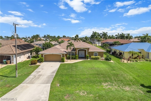 mediterranean / spanish-style home featuring a garage, solar panels, and a front lawn