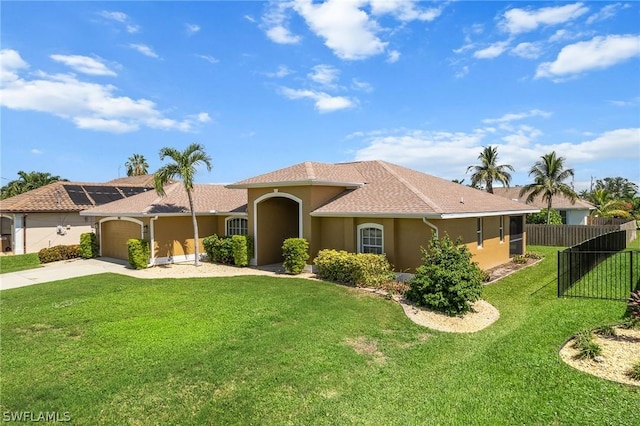 view of front of house featuring a garage and a front lawn