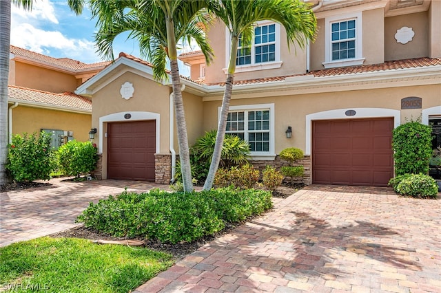 mediterranean / spanish-style house with a garage