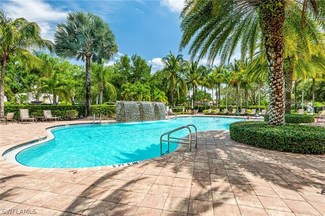 view of pool with pool water feature and a patio