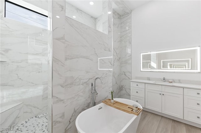 bathroom featuring separate shower and tub and vanity