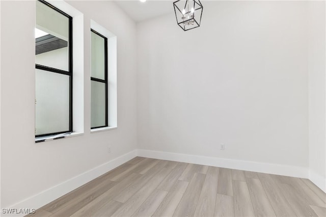 unfurnished room with light wood-type flooring