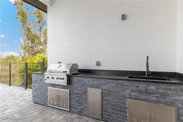 view of patio featuring area for grilling, sink, and exterior kitchen