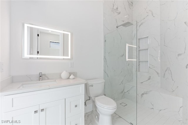 bathroom with a tile shower, vanity, and toilet