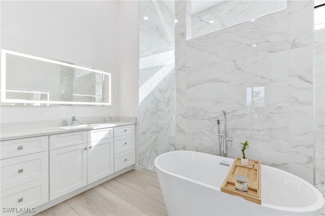 bathroom with vanity and a bath