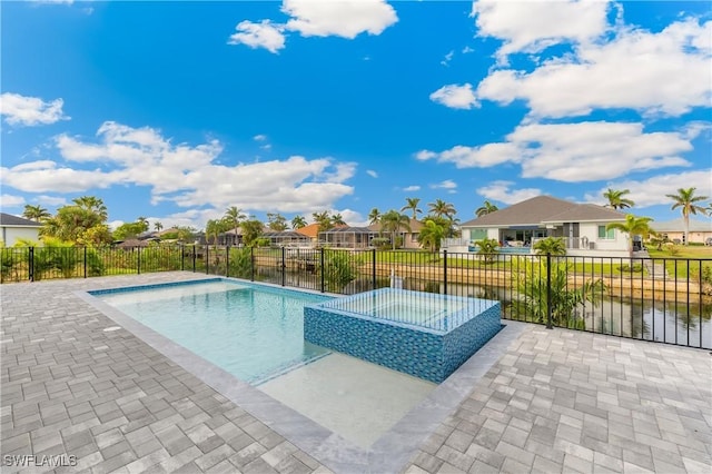 view of pool featuring a jacuzzi, a water view, and a patio