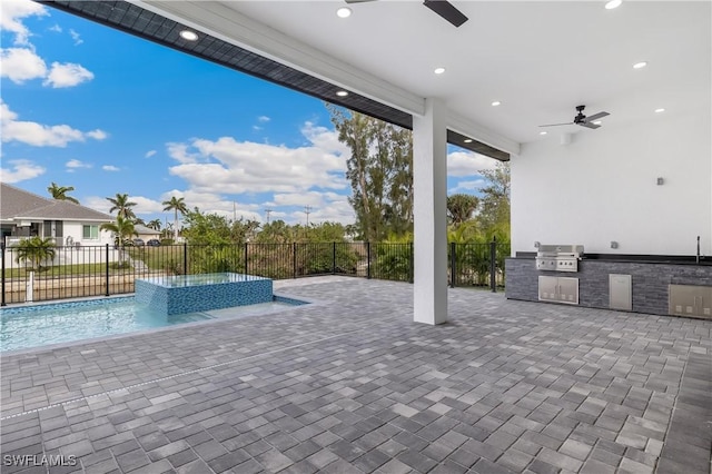 view of pool featuring grilling area, ceiling fan, an in ground hot tub, exterior kitchen, and a patio