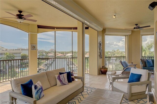 sunroom / solarium featuring ceiling fan