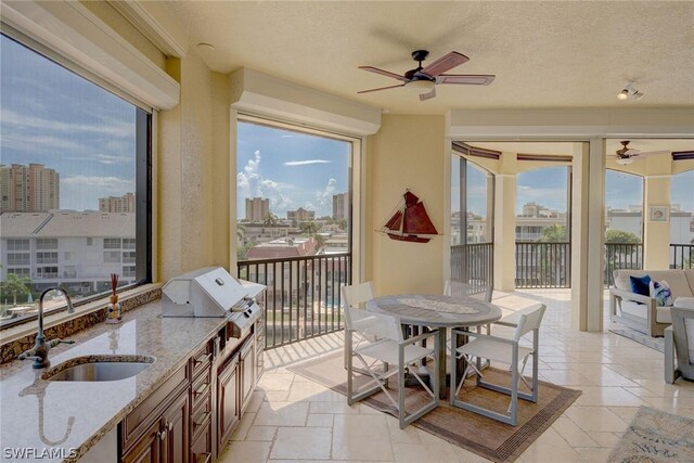 interior space with sink and ceiling fan