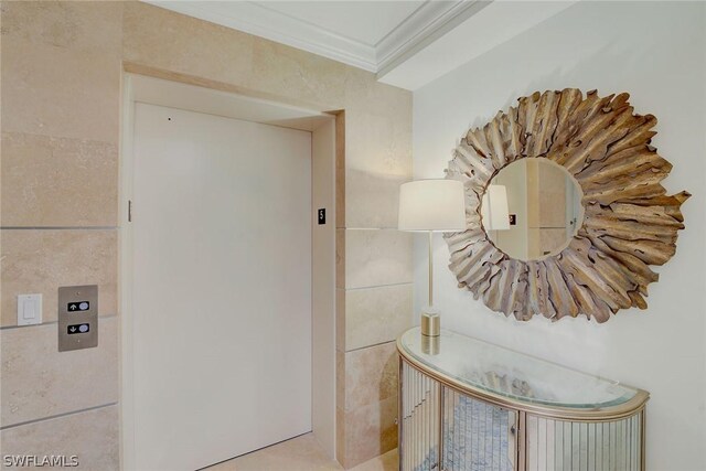 hallway with elevator and ornamental molding