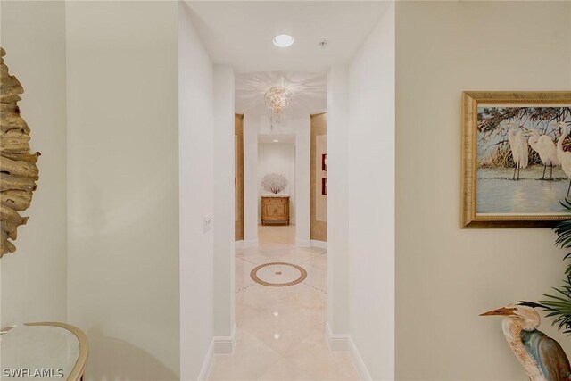 hall featuring light tile patterned flooring