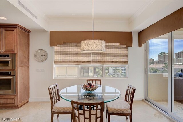 tiled dining room with crown molding