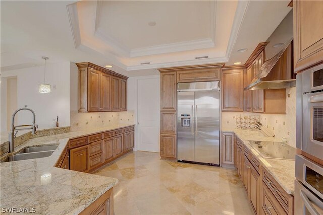 kitchen with decorative backsplash, a raised ceiling, appliances with stainless steel finishes, and sink