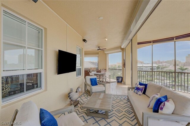 interior space with expansive windows, a textured ceiling, and ceiling fan