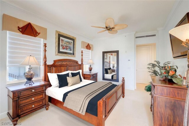 bedroom featuring crown molding, light colored carpet, and ceiling fan